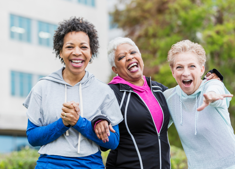 Three middle aged ladies in workout gear laughing
