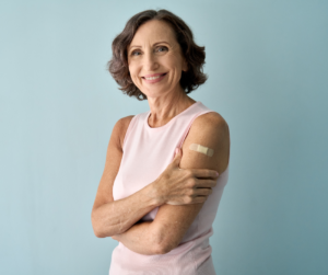 older white woman in short sleeves with a bandage on her shoulder